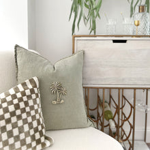 Load image into Gallery viewer, Sage tree tropical style cushion with brass palm cushion accessory. 50cm x 50cm cushion
