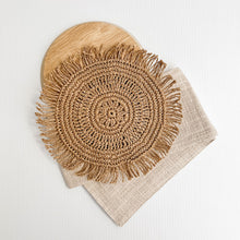 Load image into Gallery viewer, White boho cushion with stone natural colour strip wrapped around the cushion with a woven raffia disk attached to the front. The perfect Boho Accessory.

